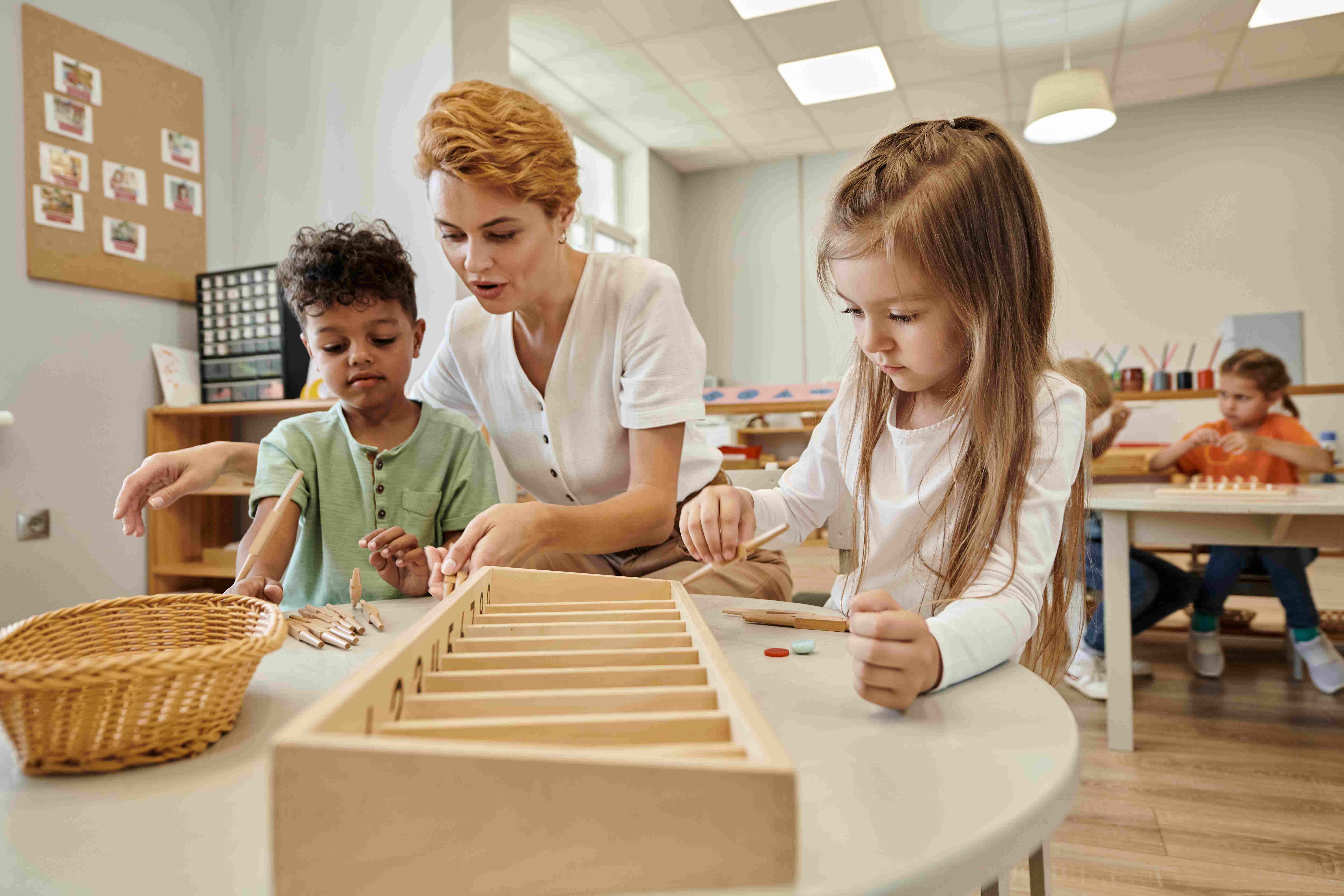 teacher-talking-to-multiethnic-kids-while-playing-Villa-montessori